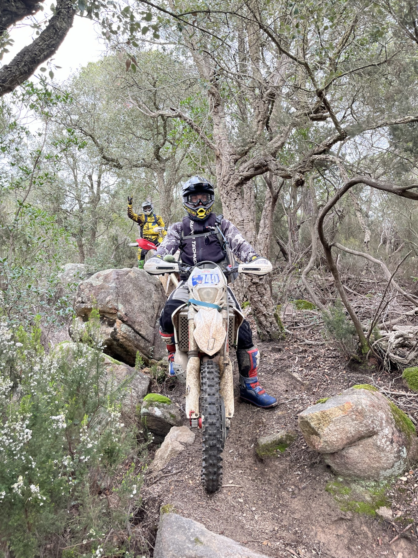 Enduro riders on a forest trail in Costa Brava