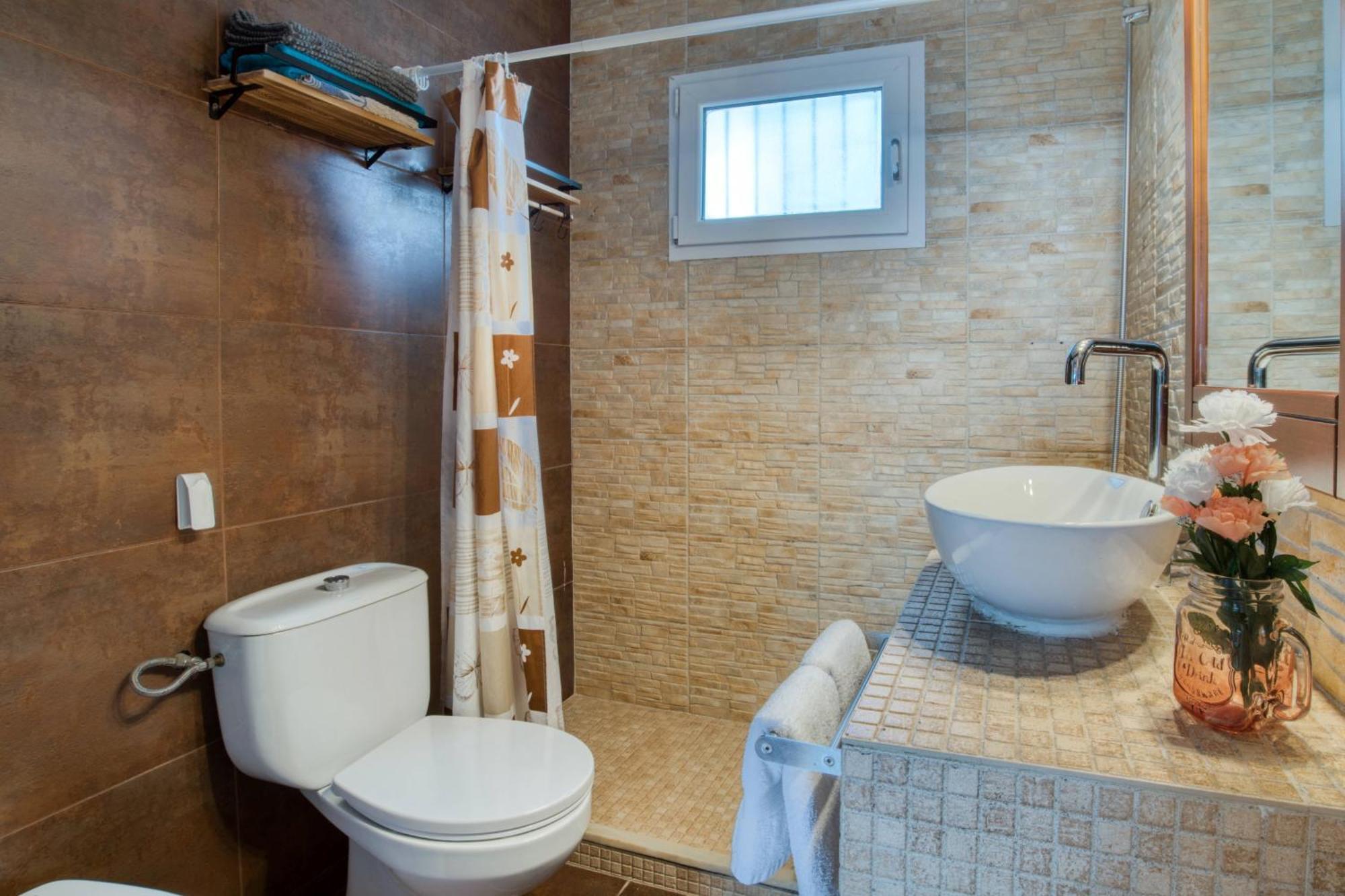 Bathroom with walk-in shower and stone tiling