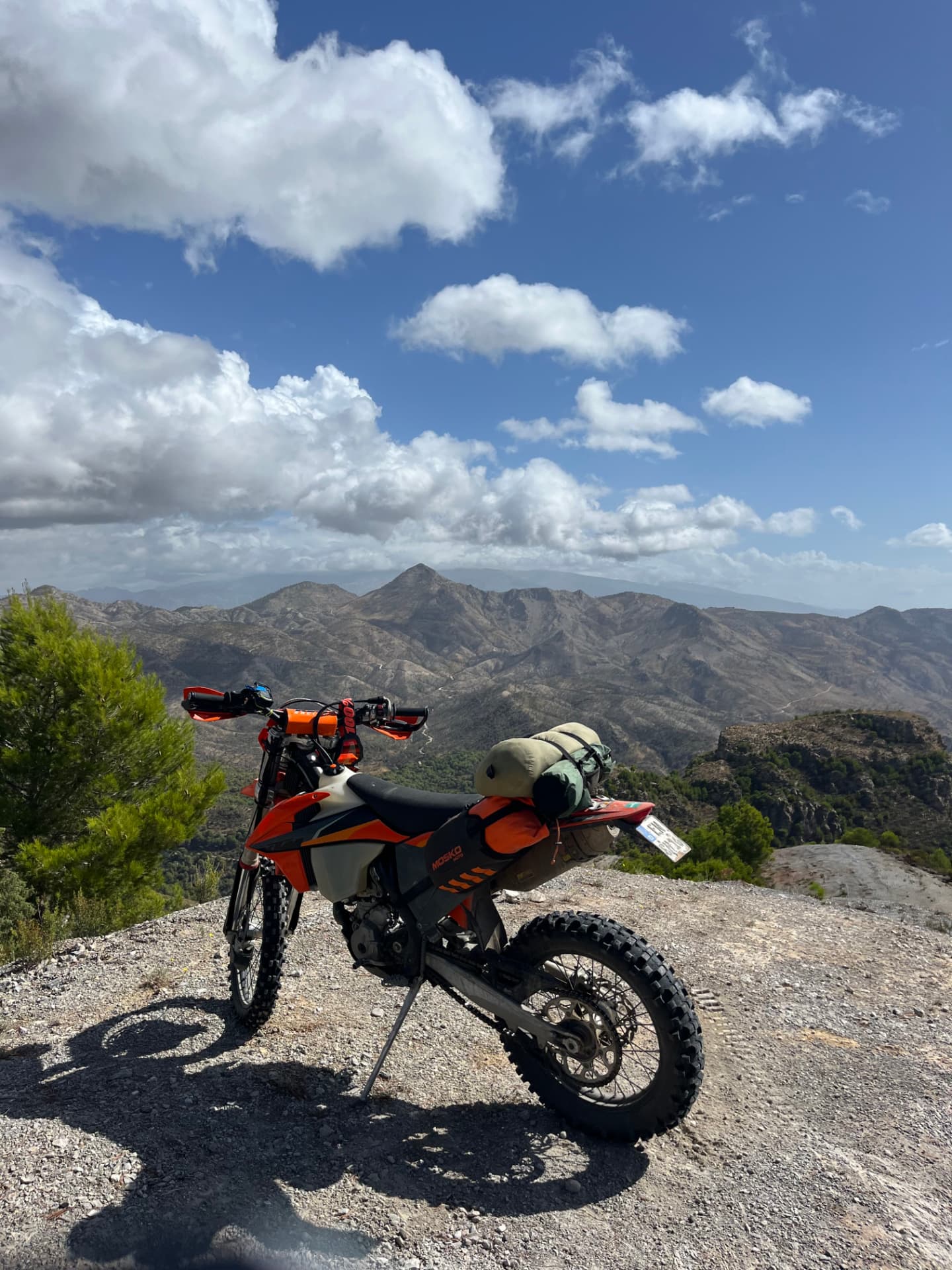 Enduro motorcycle overlooking a rugged mountain landscape