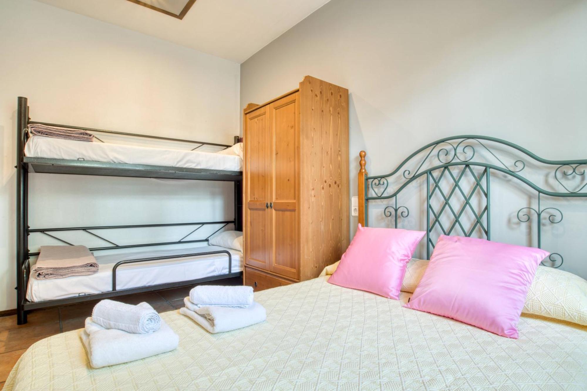 Second bedroom with double bed and bunk beds